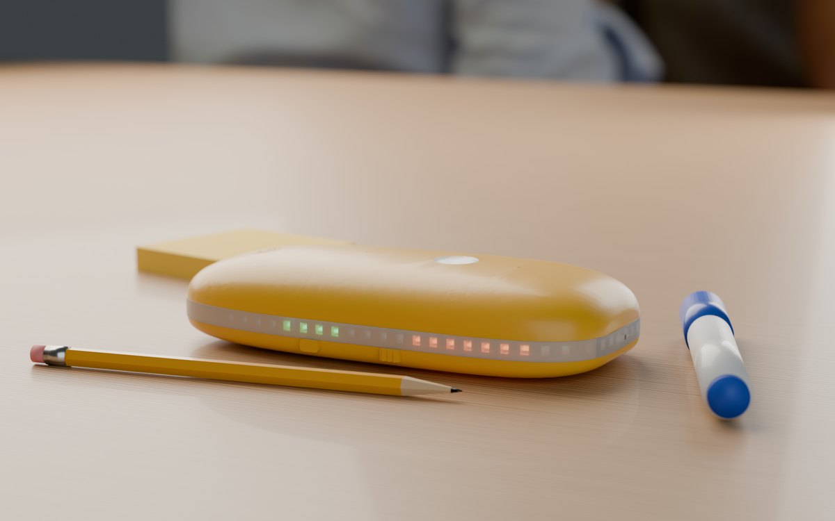 The Goldfish recorder, a yellow pebble with a ring of lights, on a meeting table