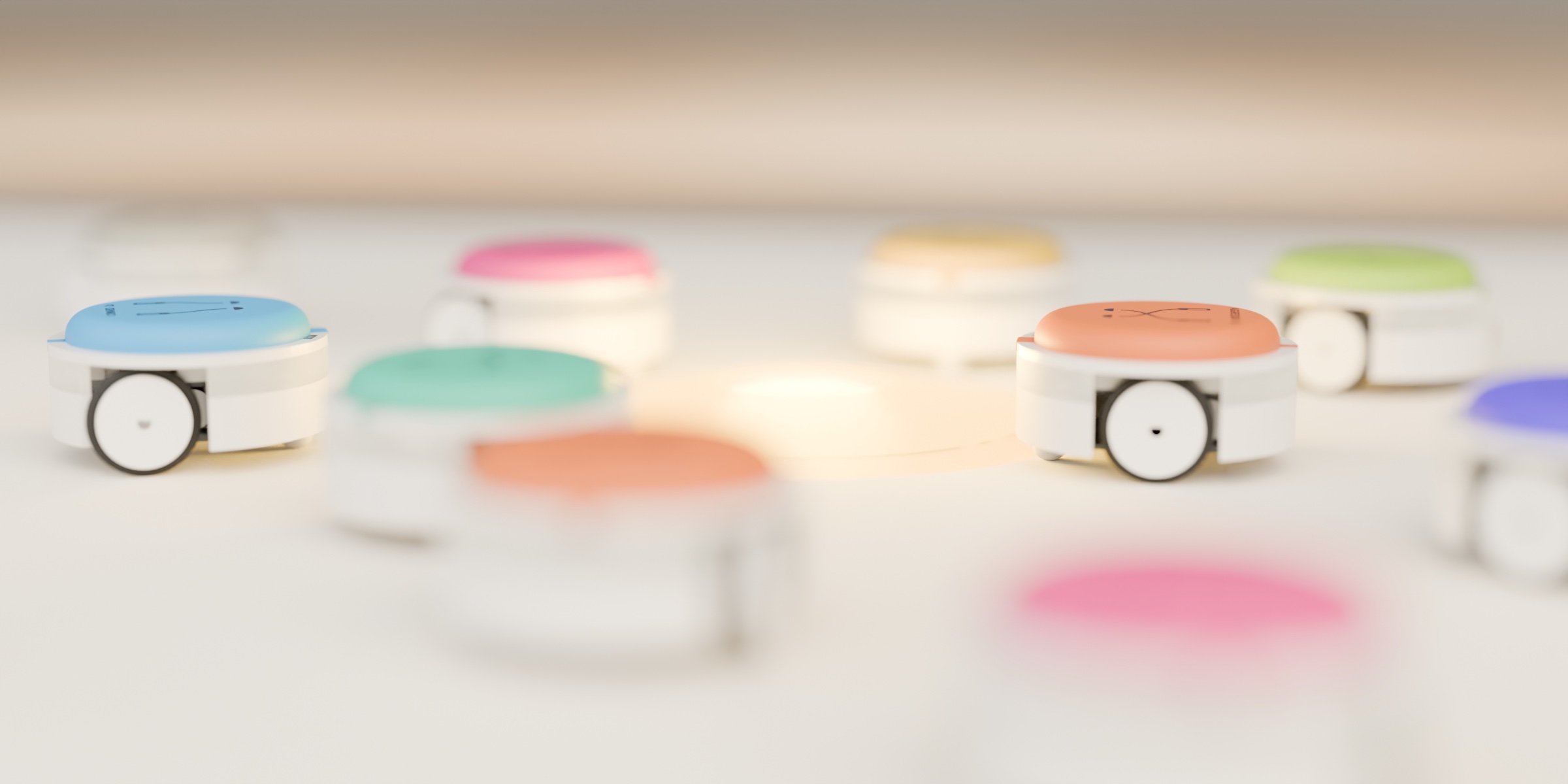 Small round robots with coloured hats racing toward a glowing light pad on a felt mat.